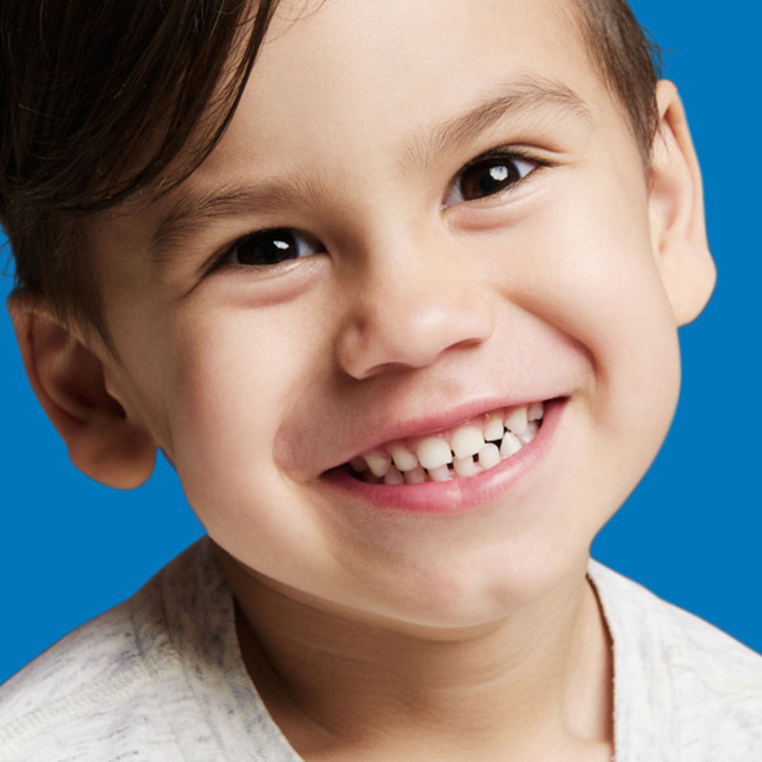 Smiling young boy with dark hair, featured on Dovorany Orthodontics Rising Star treatment page